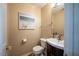Cozy powder room with vanity, updated fixtures, and beach-themed decor at 121 Walter Hagen Dr, Mebane, NC 27302