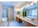 Elegant bathroom featuring double sinks, a shower, and a separate tub at 121 Walter Hagen Dr, Mebane, NC 27302