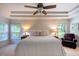 Bright bedroom with a king bed, tray ceiling, and large windows bringing in lots of light at 121 Walter Hagen Dr, Mebane, NC 27302