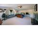 Spacious bedroom with a ceiling fan, bed, couch, and shelf displaying trophies at 121 Walter Hagen Dr, Mebane, NC 27302