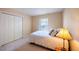 Cozy bedroom with a plush bed, bedside lamp, and closet at 121 Walter Hagen Dr, Mebane, NC 27302
