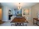 Elegant dining room with modern chandelier and natural light with a view to the main living spaces at 121 Walter Hagen Dr, Mebane, NC 27302