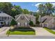 Beautiful tan home with well-kept landscaping, a spacious driveway, and mature trees surrounding the property at 121 Walter Hagen Dr, Mebane, NC 27302