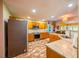 Well-lit eat-in kitchen featuring granite countertops, stainless steel appliances, and brick flooring at 121 Walter Hagen Dr, Mebane, NC 27302