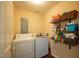 Functional laundry room with washer, dryer, and ample shelving at 121 Walter Hagen Dr, Mebane, NC 27302