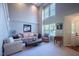 Inviting living room with soaring ceilings, large windows, and comfortable seating arrangements at 121 Walter Hagen Dr, Mebane, NC 27302