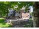 Charming brick home with a stone patio, screened porch, and beautifully landscaped backyard at 1218 Crystalwater Dr, Fuquay Varina, NC 27526