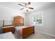 Traditional bedroom featuring a wooden bed frame, side table, and a window with natural light at 1218 Crystalwater Dr, Fuquay Varina, NC 27526