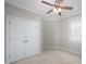 Carpeted bedroom with a window, neutral walls and a double closet at 1218 Crystalwater Dr, Fuquay Varina, NC 27526