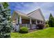 Charming single-story home featuring a welcoming brick porch with white columns and lush landscaping at 1218 Crystalwater Dr, Fuquay Varina, NC 27526