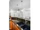 Kitchen island with sink and stainless steel faucet that is connected to the living room at 1218 Crystalwater Dr, Fuquay Varina, NC 27526