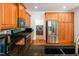 Kitchen featuring wooden cabinets, stainless steel appliances, and a view of the laundry area at 1218 Crystalwater Dr, Fuquay Varina, NC 27526