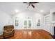 Spacious living room features a ceiling fan, hardwood floors, and French doors leading to the outside at 1218 Crystalwater Dr, Fuquay Varina, NC 27526