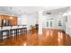 Open-concept living area with hardwood floors, kitchen bar, and natural light at 1218 Crystalwater Dr, Fuquay Varina, NC 27526