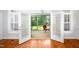 Hardwood floors lead to a bright sunroom with screened windows, flooding the space with light at 1218 Crystalwater Dr, Fuquay Varina, NC 27526
