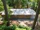 Aerial view of backyard with a fire pit surrounded by lush green trees and foliage at 126 Barclay Rd, Chapel Hill, NC 27516