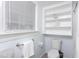 Bright bathroom with built-in shelving, gray floors, and white toilet at 126 Barclay Rd, Chapel Hill, NC 27516