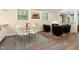 Cozy dining area with seating, sleek hardwood flooring, and a modern rug at 126 Barclay Rd, Chapel Hill, NC 27516