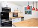 Well-lit kitchen with stainless steel appliances, butcher block countertops, and decorative pendant lights at 126 Barclay Rd, Chapel Hill, NC 27516