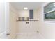 Simple laundry room with light-colored walls, shelving, and hookups at 126 Barclay Rd, Chapel Hill, NC 27516