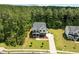 A beautiful aerial view showing the home's lush surroundings and curb appeal at 1338 The Parks Dr, Pittsboro, NC 27312