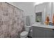 Neutral toned bathroom with a tub/shower, patterned shower curtain, and vanity with mirror at 1338 The Parks Dr, Pittsboro, NC 27312