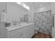 Bathroom with double sink vanity, clean white cabinets, and shower/tub combo at 1338 The Parks Dr, Pittsboro, NC 27312
