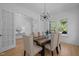 Bright dining room with modern chandelier, wood floors, and natural light at 1338 The Parks Dr, Pittsboro, NC 27312
