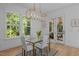 Bright dining room with a modern chandelier and a view of the outdoors at 1338 The Parks Dr, Pittsboro, NC 27312