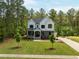 Expansive front lawn, with a basketball court and a backdrop of lush green trees at 1338 The Parks Dr, Pittsboro, NC 27312