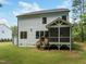 View of the side of the house with a screened porch and green lawn at 1338 The Parks Dr, Pittsboro, NC 27312