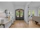 Inviting foyer with wood floors, a decorative mirror, and a stylish wood door at 1338 The Parks Dr, Pittsboro, NC 27312