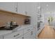 Kitchen area featuring white cabinets, marble countertops, and modern appliances at 1338 The Parks Dr, Pittsboro, NC 27312
