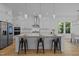 Modern kitchen with a large island, white cabinets, and stainless steel appliances at 1338 The Parks Dr, Pittsboro, NC 27312