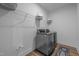 Functional laundry room with washer, dryer, storage shelves and modern design elements at 1338 The Parks Dr, Pittsboro, NC 27312