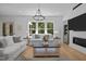 Comfortable living room featuring a fireplace, TV, and ample seating with large windows at 1338 The Parks Dr, Pittsboro, NC 27312