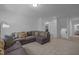 Living room featuring a comfortable sectional sofa and neutral decor at 1338 The Parks Dr, Pittsboro, NC 27312
