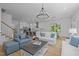Open-concept living room showcasing hardwood floors and a view of the kitchen and dining area at 1338 The Parks Dr, Pittsboro, NC 27312