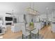 Inviting open-concept living space with a dining area, fireplace, and modern furnishings at 1338 The Parks Dr, Pittsboro, NC 27312