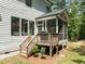 Side view of the screened-in porch with wooden stairs leading up at 1338 The Parks Dr, Pittsboro, NC 27312