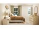 Cozy bedroom featuring a bed, curtains, a dresser and stylish decor at 1412 Maple Branch Cir # 35, Graham, NC 27253
