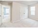 Neutral bedroom with adjacent entrance and closet with double doors, and lots of natural light at 1412 Maple Branch Cir # 35, Graham, NC 27253