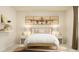 Well-lit bedroom featuring a bed, bedside tables with lamps, and airplane-themed wall art at 1412 Maple Branch Cir # 35, Graham, NC 27253