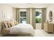 Bright bedroom with large windows offering natural light, decorative pillows, and wood dresser at 1412 Maple Branch Cir # 35, Graham, NC 27253
