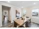Dining room with wood table, six chairs, and natural light from windows at 1412 Maple Branch Cir # 35, Graham, NC 27253