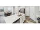 Bright kitchen with stainless steel appliances, white cabinets, and a quartz countertop island at 1412 Maple Branch Cir # 35, Graham, NC 27253
