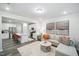Bright living space featuring a modern kitchen, a gray sofa, and stylish decor at 1412 Maple Branch Cir # 35, Graham, NC 27253