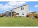 Spacious backyard featuring a screened-in porch, play set, and well-manicured lawn at 145 Cassada Ct, Holly Springs, NC 27540