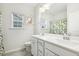 Bathroom featuring a double sink vanity, tile flooring, and decorated with leafy green accents at 145 Cassada Ct, Holly Springs, NC 27540
