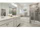 Elegant bathroom features a double vanity, a soaking tub, and a glass-enclosed shower for spa experience at 145 Cassada Ct, Holly Springs, NC 27540
